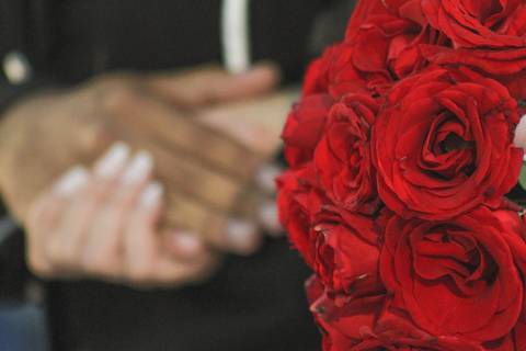 Noiva e noivo durante a cerimônia religiosa na Igreja Nossa Senhora da Saúde em Casimiro de Abreu RJ Destaque para o Buquê de flores vermalhas'