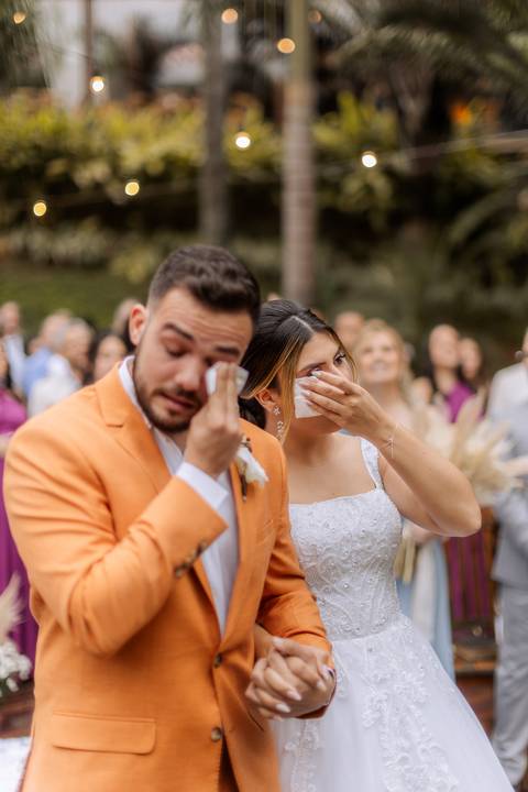 Noivos emocionados em casamento ao ar livre'