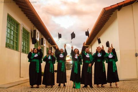 Formandos jogando o chapéu no dia da colação de grau'