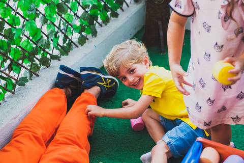 Menino empurra o monitor e cai na gargalhada'