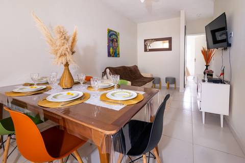 Fotografia profissional de uma casa no bairro Jardim Samambaia, em Praia Grande, SP, pelo fotógrafo profissional de imóveis Fernando Freire, foto para anúncio no Airbnb e Booking. Ambiente da sala completa e mobiliada.'