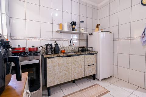 Fotografia profissional de uma casa no bairro Jardim Samambaia, em Praia Grande, SP, pelo fotógrafo profissional de imóveis Fernando Freire, foto para anúncio no Airbnb e Booking. Ambiente da cozinha completa e mobiliada.'