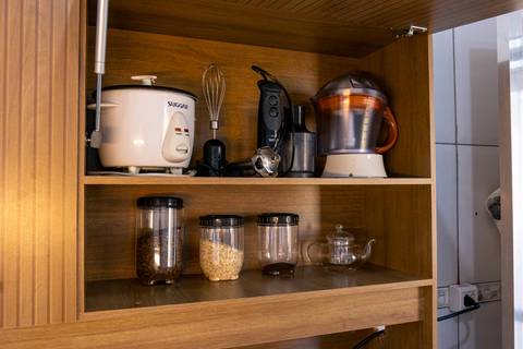 Fotografia profissional de uma casa no bairro Jardim Samambaia, em Praia Grande, SP, pelo fotógrafo profissional de imóveis Fernando Freire, foto para anúncio no Airbnb e Booking. Ambiente da cozinha completa e mobiliada.'