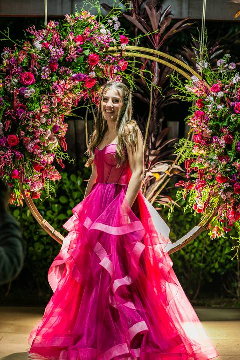 sentada numa guirlanda de flores sorrindo'