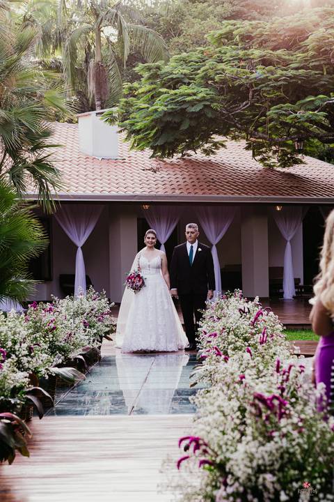 noiva entrando linda, pai do lado esquerdo dela e buque rosa cerimonia por do sol linda '