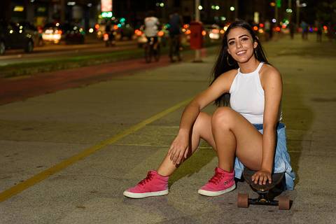 menina sentada no skate'