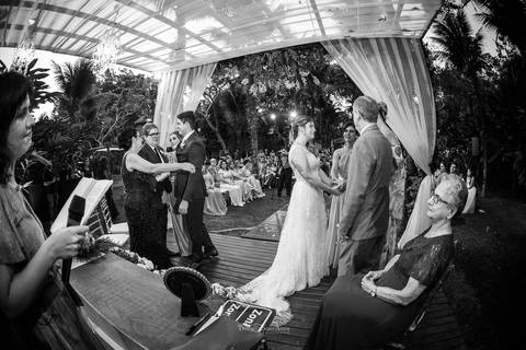 noivos no altar tenda de madeira tecidos preto e branco'