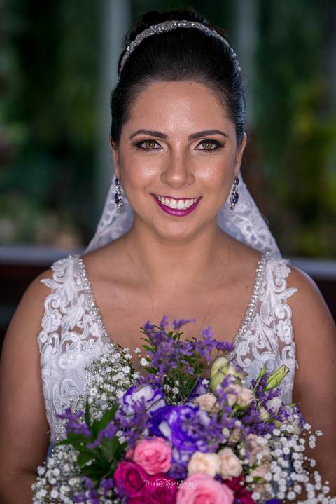 noiva sorri vestido maquiagem buque tons de rosa e lilás'