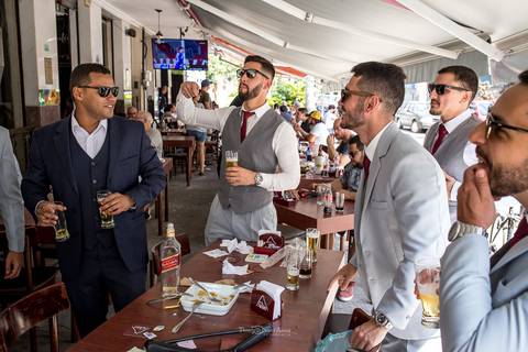 noivo bebe com os padrinhos'