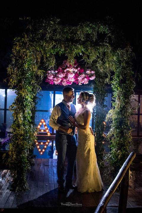 noivos abraçados decoração flores tons de rosa vegetação'