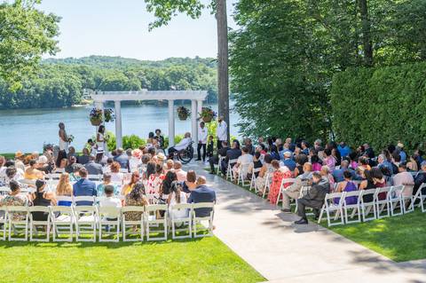 Photo by Vanessa Trettel,
Wedding photographer on location at The Water View, Monroe, CT in July 2022.
It's an image of the ceremony with the river in the background'