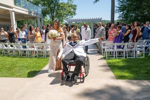 Photo by Vanessa Trettel,
Onsite wedding photographer at The Water View, Monroe, CT in July 2022.
It is an image of the groom in his wheelchair at The Water View Venue in Monroe, CT'