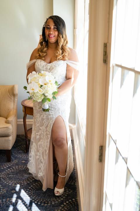 Photo by Vanessa Trettel,
Wedding photographer at Venue The Water View, Monroe, CT in July 2022.
It is an image of the bride standing with the bouquet'