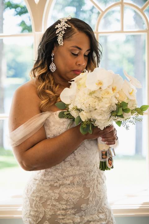 Photo by Vanessa Trettel,
Wedding photographer at Venue The Water View, Monroe, CT in July 2022.
It is an image of the bride standing with the bouquet'