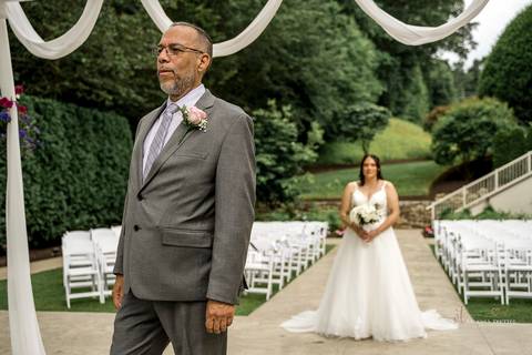 Briana shares a heartfelt First Look with her father at The Waterview in Monroe, CT. Her father’s eyes light up as he sees her in her wedding dress for the first time, capturing an unforgettable, emotional moment filled with love and pride.'