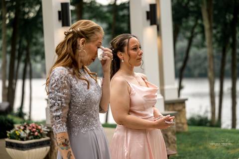 Captured in golden light, Briana & Nicholas steal a quiet moment together at The Waterview in Monroe, CT. The serene lake in the background enhances the romantic atmosphere as they embrace, lost in the love and joy of their special day.'