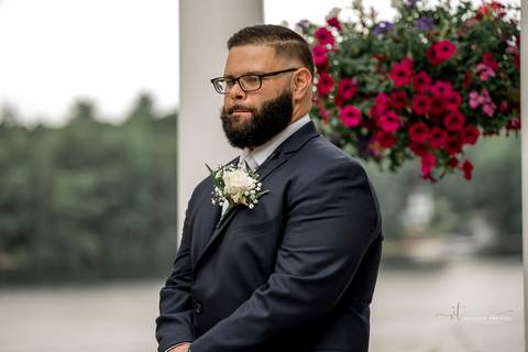 A lively wedding ceremony at The Waterview in Monroe, CT. A groomsman joyfully hands out beers to smiling guests, setting a fun and unique tone that perfectly matches the joyful personalities of Briana & Nicholas.'