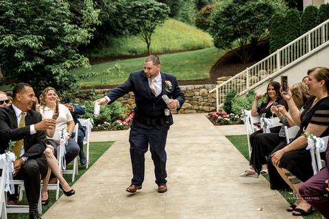 Captured in golden light, Briana & Nicholas steal a quiet moment together at The Waterview in Monroe, CT. The serene lake in the background enhances the romantic atmosphere as they embrace, lost in the love and joy of their special day.'