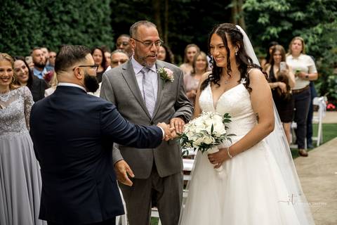 Briana shares a heartfelt First Look with her father at The Waterview in Monroe, CT. Her father’s eyes light up as he sees her in her wedding dress for the first time, capturing an unforgettable, emotional moment filled with love and pride.'