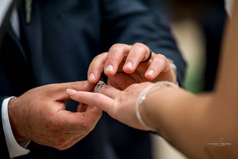 Briana & Nicholas share a joyful moment during their wedding at The Waterview in Monroe, CT. Surrounded by friends and family, they stand hand in hand, beaming with happiness as they exchange vows under a beautifully decorated arch'
