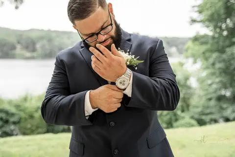 Captured in golden light, Briana & Nicholas steal a quiet moment together at The Waterview in Monroe, CT. The serene lake in the background enhances the romantic atmosphere as they embrace, lost in the love and joy of their special day.'