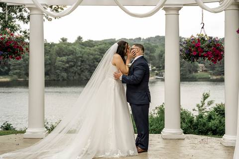 A jubilant wedding reception at The Waterview in Monroe, CT. The bride and groom dance the night away, surrounded by cheering guests. The energy is electric as the celebration continues, perfectly capturing the spirit of Briana & Nicholas’s love story.'