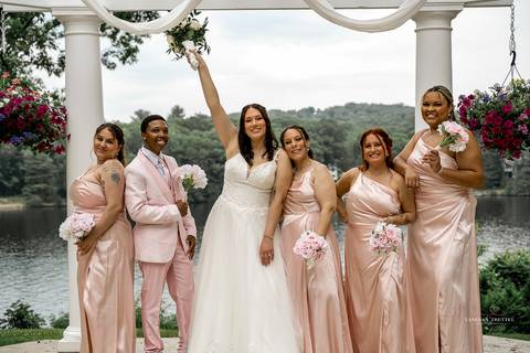 Captured in golden light, Briana & Nicholas steal a quiet moment together at The Waterview in Monroe, CT. The serene lake in the background enhances the romantic atmosphere as they embrace, lost in the love and joy of their special day.'