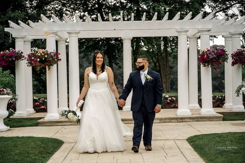Captured in golden light, Briana & Nicholas steal a quiet moment together at The Waterview in Monroe, CT. The serene lake in the background enhances the romantic atmosphere as they embrace, lost in the love and joy of their special day.'