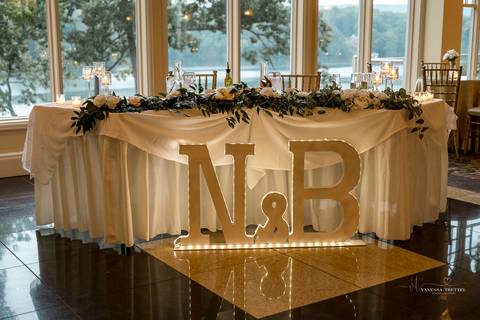 A lively wedding ceremony at The Waterview in Monroe, CT. A groomsman joyfully hands out beers to smiling guests, setting a fun and unique tone that perfectly matches the joyful personalities of Briana & Nicholas.'