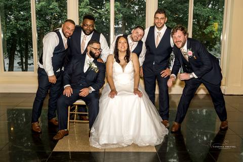 A lively wedding ceremony at The Waterview in Monroe, CT. A groomsman joyfully hands out beers to smiling guests, setting a fun and unique tone that perfectly matches the joyful personalities of Briana & Nicholas.'