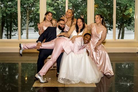 Briana & Nicholas share a joyful moment during their wedding at The Waterview in Monroe, CT. Surrounded by friends and family, they stand hand in hand, beaming with happiness as they exchange vows under a beautifully decorated arch'