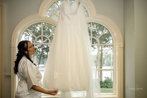 A lively wedding ceremony at The Waterview in Monroe, CT. A groomsman joyfully hands out beers to smiling guests, setting a fun and unique tone that perfectly matches the joyful personalities of Briana & Nicholas.'