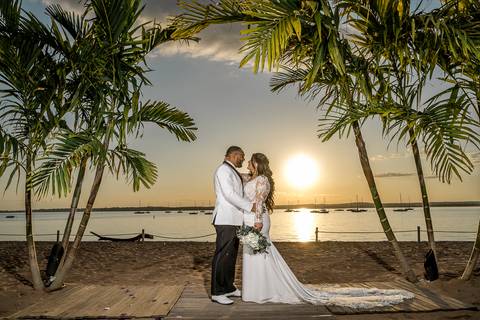 Ben, originally from Connecticut, and his bride Jessica, enjoy a joyful walk down the aisle at Anthony's Ocean View. Their smiles radiate pure happiness as they celebrate their love in front of family and friends.'