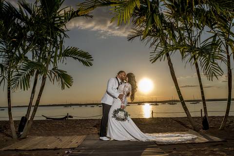 The sun sets beautifully over Anthony's Ocean View as Jessica & Ben enjoy a quiet moment together. The warm light and ocean views make for a picturesque scene, perfectly capturing the romance of their special day.'