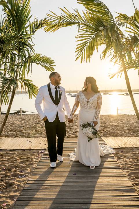 Jessica & Ben share a tender moment during their sunset ceremony at Anthony's Ocean View in New Haven, CT. The golden light reflects off the ocean, creating a stunning backdrop as they exchange vows surrounded by family and friends.'