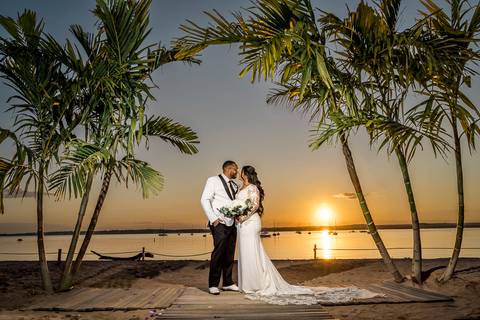 Ben, originally from Connecticut, and his bride Jessica, enjoy a joyful walk down the aisle at Anthony's Ocean View. Their smiles radiate pure happiness as they celebrate their love in front of family and friends.'