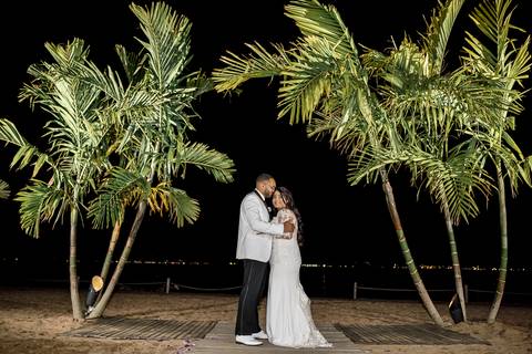 Ben, originally from Connecticut, and his bride Jessica, enjoy a joyful walk down the aisle at Anthony's Ocean View. Their smiles radiate pure happiness as they celebrate their love in front of family and friends.'