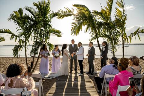 Ben, originally from Connecticut, and his bride Jessica, enjoy a joyful walk down the aisle at Anthony's Ocean View. Their smiles radiate pure happiness as they celebrate their love in front of family and friends.'