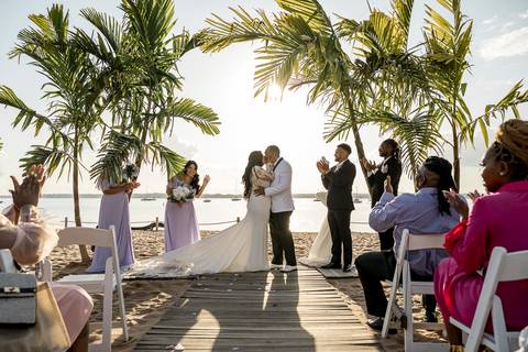 The sun sets beautifully over Anthony's Ocean View as Jessica & Ben enjoy a quiet moment together. The warm light and ocean views make for a picturesque scene, perfectly capturing the romance of their special day.'