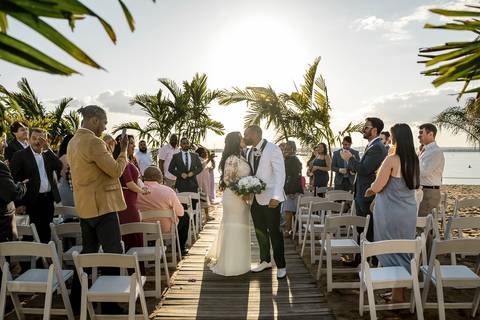 Jessica & Ben share a tender moment during their sunset ceremony at Anthony's Ocean View in New Haven, CT. The golden light reflects off the ocean, creating a stunning backdrop as they exchange vows surrounded by family and friends.'