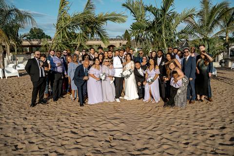 Jessica & Ben, a couple from California, embrace during their wedding at Anthony's Ocean View. The groom’s Connecticut roots are celebrated as they stand together, beaming with happiness under the glowing sunset sky.'