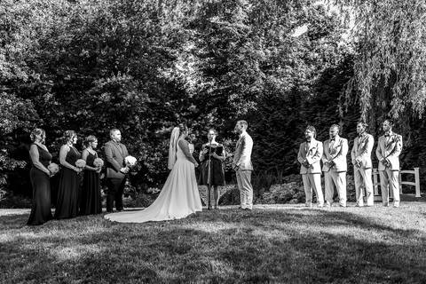Amanda and Vinny exchanging wedding rings during their ceremony at Woodwinds, their eyes locked in a moment of pure love and commitment.'