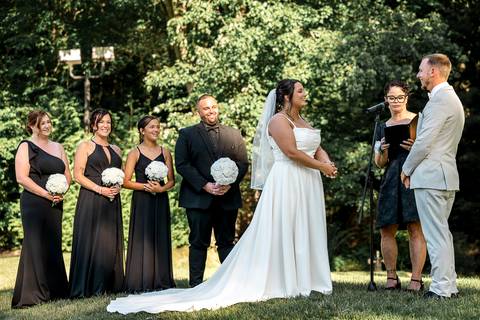 Amanda and Vinny exchanging wedding rings during their ceremony at Woodwinds, their eyes locked in a moment of pure love and commitment.'