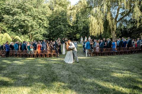 The whole family posing together in front of the reception venue at Woodwinds, dressed in elegant wedding attire, radiating happiness.'