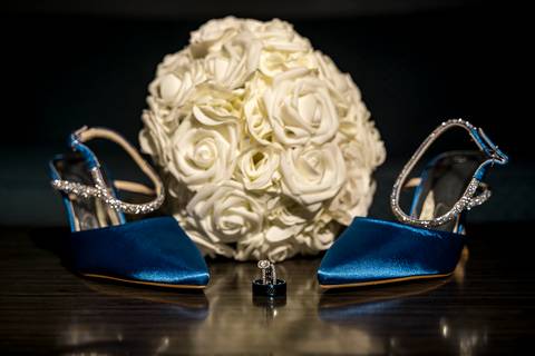 A close-up of the bride’s elegant white bouquet, featuring soft blooms and delicate greenery, resting gently in her hands as she prepares for the ceremony.'