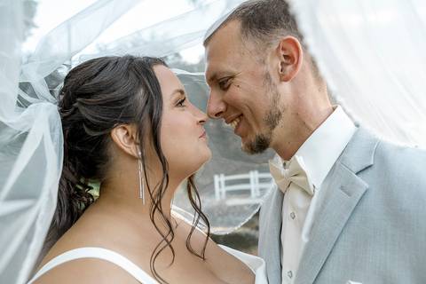 Romantic shot of Amanda and Vinny sharing a quiet moment by the fountain at Woodwinds, foreheads touching and eyes closed.'