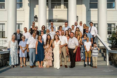 Full wedding party and family gather for a joyful group photo after the ceremony. Natural, documentary-style wedding photography in Mystic, CT.'