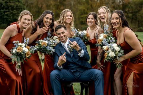 Cara walks down the aisle at St. James Catholic Church, her lace veil trailing behind as she beams with joy, surrounded by the church’s timeless architecture and a sea of emotional loved ones.'