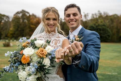 The couple shares a kiss under the golden autumn sunlight at StoneHurst at Hampton Valley, with vibrant foliage surrounding them, capturing the essence of their beautiful fall wedding in CT'