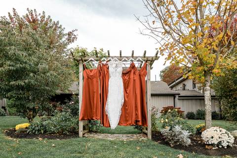 The couple shares a kiss under the golden autumn sunlight at StoneHurst at Hampton Valley, with vibrant foliage surrounding them, capturing the essence of their beautiful fall wedding in CT'